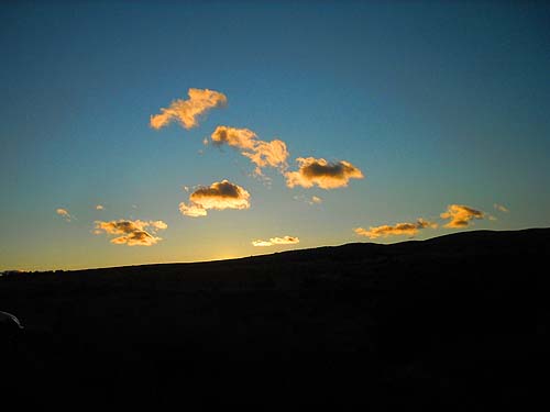 sun sinks behind dry hills, Winchester Road SW of Yakima, WA