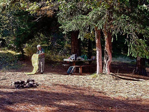 Rod Crawford breaking camp at Outlet Creek Campground near Glenwood, Klickitat County, Washington