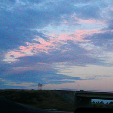 pink sunset cloud visible from front seat, south of Olympia along I-5, 7 October 2024