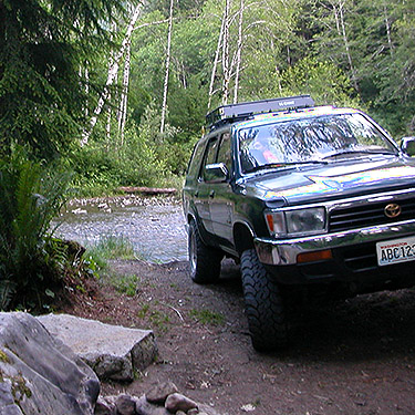 SUV at campsite along road, seen hiking to spider collecting site on upper Middle Fork Snoqualmie River, King County, Washington