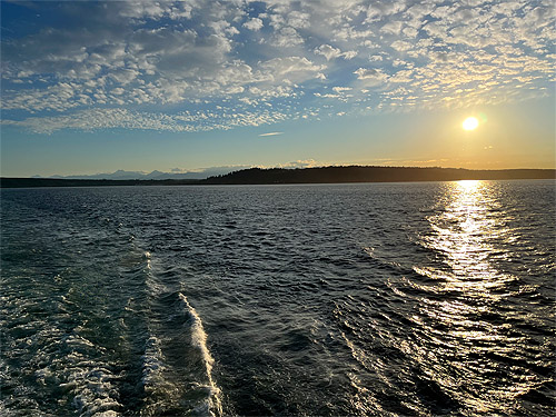 sinking sun behind Kingston-Edmonds ferry, Washington, 29 June 2023