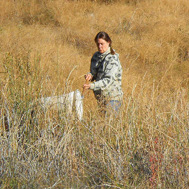 Kathy Whaley sweeping grass, Meyers Falls Cemetery, Kettle Falls, Washington