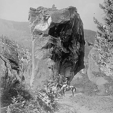gigantic boulder on trail, historic stock photo