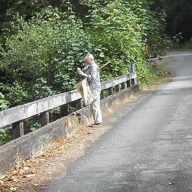 Laurel Ramseyer collects from bridge, South Fork Sol Duc River site, Clallam County, Washington