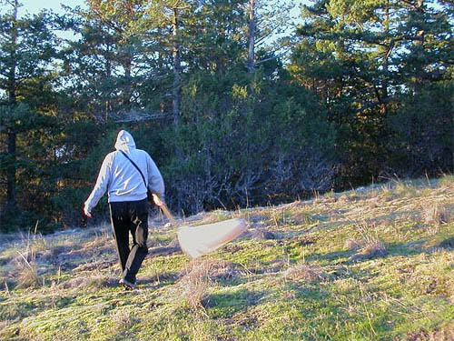 Laurel Ramseyer sweeping exceedingly sparse grass, Fidalgo Head, west of Anacortes, Washington
