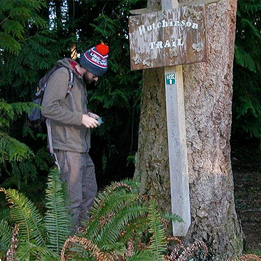 Ben Diehl hunts spiders on tree trunk, Hutchison Park, Camano Island, Washington