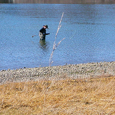 woman fishing at unnamed park on Little Skookum Inlet, Mason County, Washington