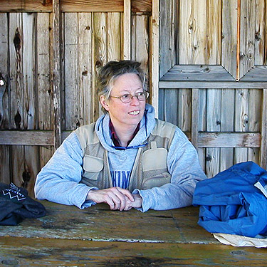 Laurel Ramseyer relaxing at picnic table, unnamed park on shore of Little Skookum Inlet, Mason County, Washington