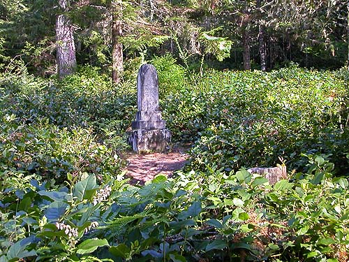 Ann Clements monument in glade in the salal