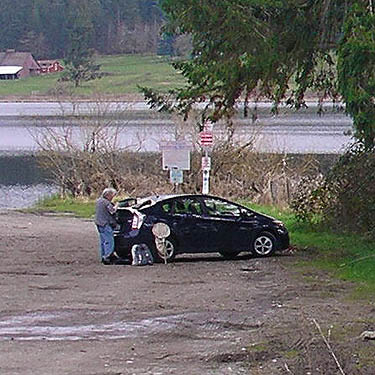 Rod Crawford sifting litter on car, Rapjohn Lake, Pierce County, Washington