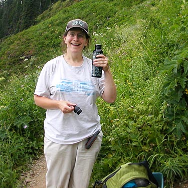 Angela Winner swigs water on trail from Sauk Mountain, Skagit County, Washington